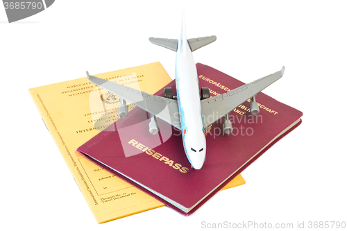 Image of Toy plane on passport and vaccination card