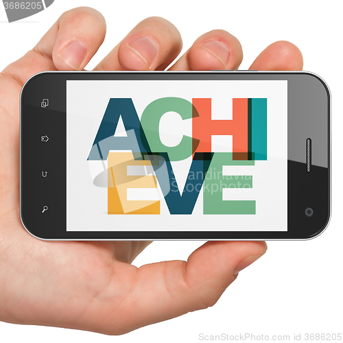Image of Business concept: Hand Holding Smartphone with Achieve on  display