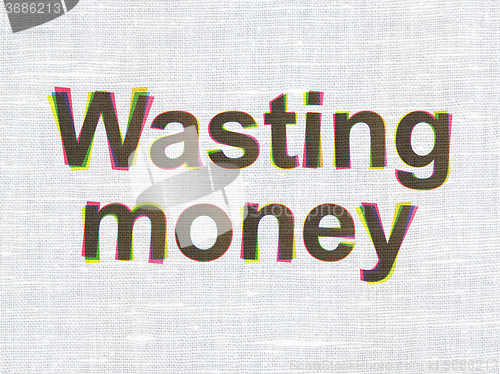 Image of Money concept: Wasting Money on fabric texture background