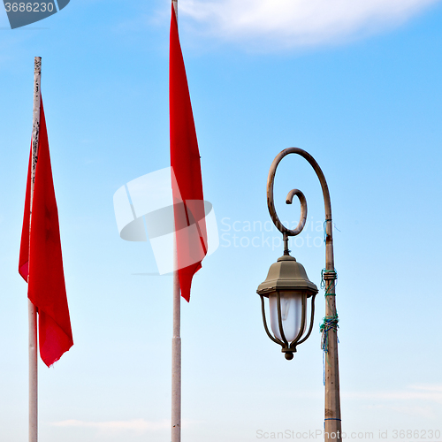 Image of tunisia  waving flag in the blue sky  colour and street lamp 