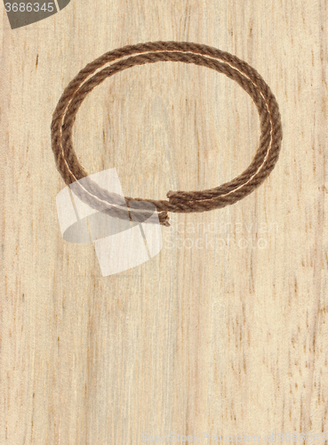 Image of rope frame on wood background