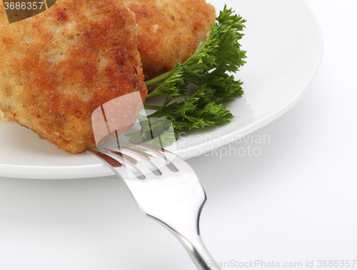 Image of roasted cutlets with fork