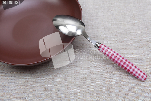 Image of empty plate with spoon 