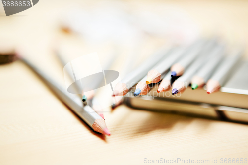 Image of Close up of color pencils over wooden background