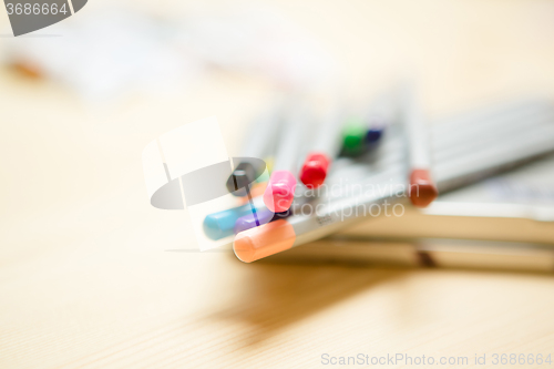 Image of Close up of color pencils over wooden background