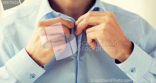 Image of close up of man in shirt dressing 