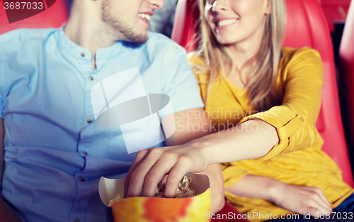 Image of happy couple watching movie in theater or cinema