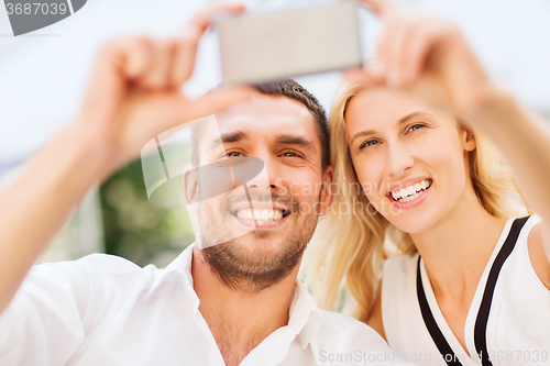Image of happy couple taking selfie with smartphone 