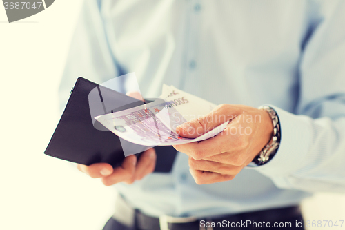 Image of close up of businessman hands holding money