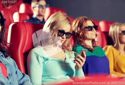 Image of happy woman with smartphone in 3d movie theater