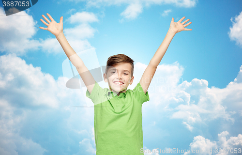 Image of happy boy in polo t-shirt raising hands up