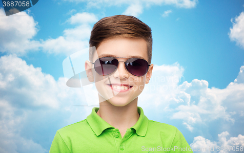 Image of smiling boy in sunglasses and green polo t-shirt