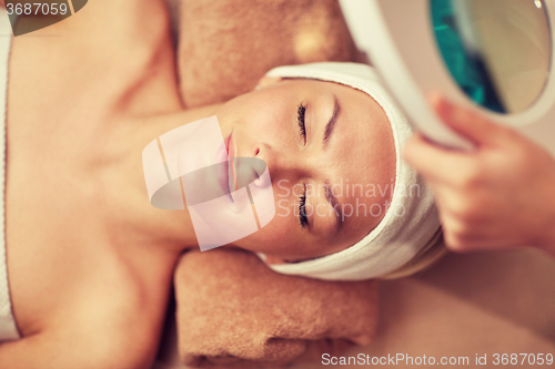 Image of close up of young woman lying in spa