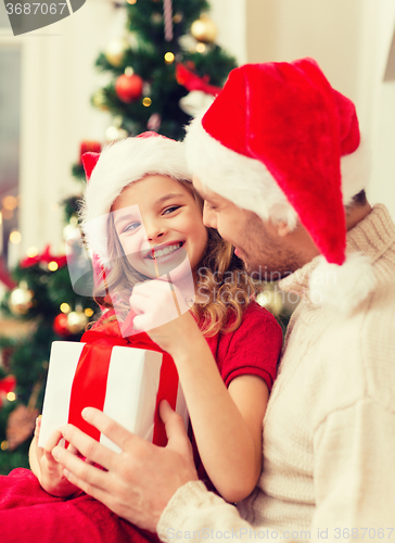 Image of smiling father and daughter opening gift box