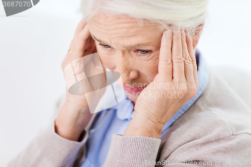 Image of face of senior woman suffering from headache