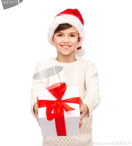 Image of smiling happy boy in santa hat with gift box