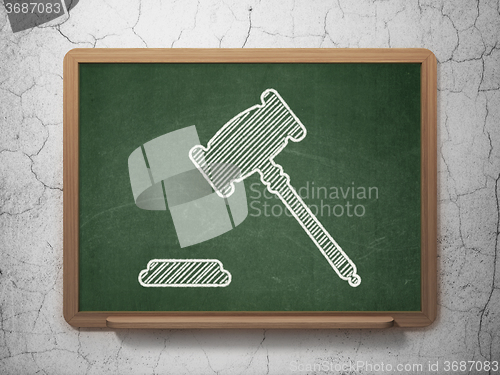 Image of Law concept: Gavel on chalkboard background