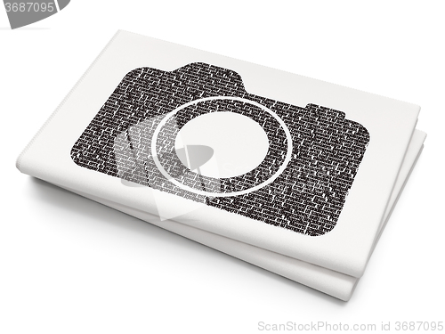 Image of Travel concept: Photo Camera on Blank Newspaper background