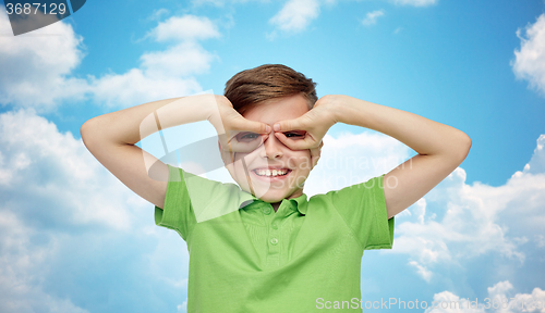 Image of happy boy in t-shirt having fun and making faces