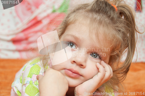 Image of The three-year girl interested looking at left