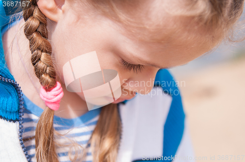 Image of Upset girl turns away and hides her face