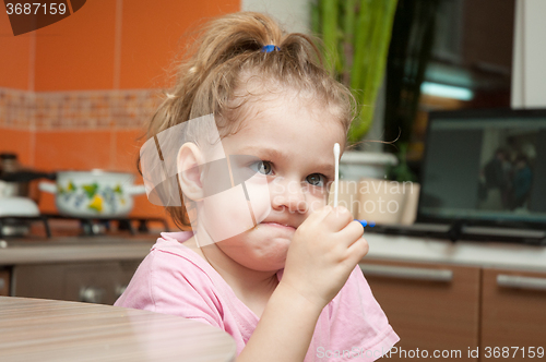 Image of Girl with a funny looking angrily at a cotton swab