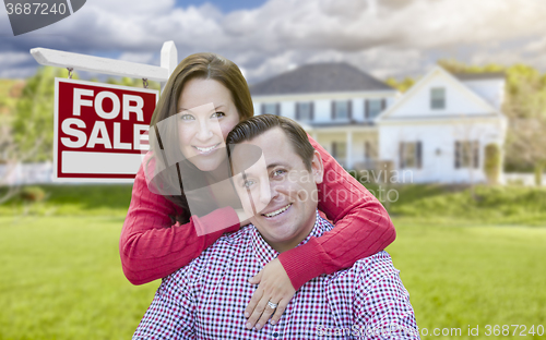 Image of Happy Couple In Front of For Sale Sign and House