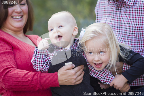 Image of Mommy and Daddy Having Fun with Baby Brother And Sister
