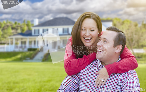 Image of Happy Couple Outdoors In Front of Beautiful House