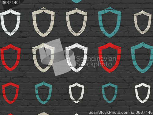 Image of Security concept: Contoured Shield icons on wall background