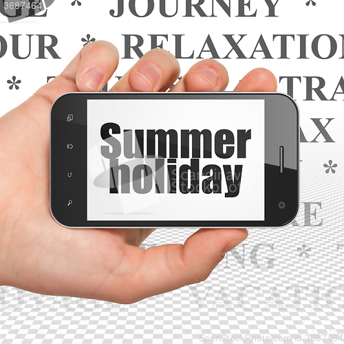 Image of Tourism concept: Hand Holding Smartphone with Summer Holiday on display