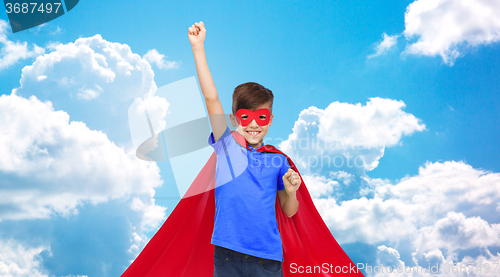 Image of boy in red super hero cape and mask showing fists