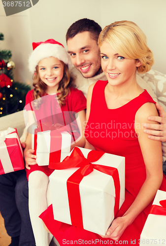 Image of smiling family holding many gift boxes