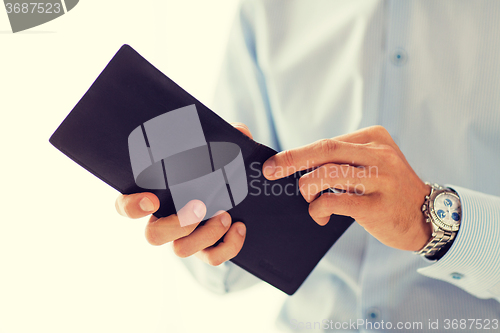 Image of close up of businessman hands holding open wallet