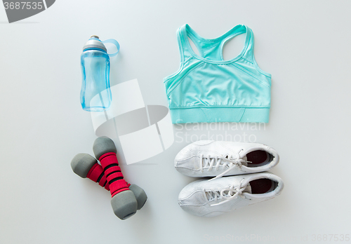 Image of close up of sportswear, dumbbells and bottle
