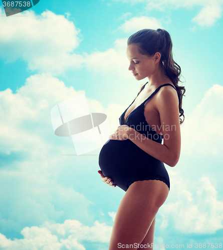 Image of happy pregnant woman in black underwear