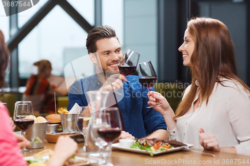 Image of couple dining and drinking wine at restaurant