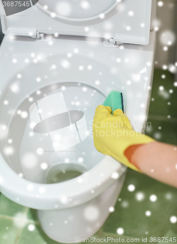 Image of close up of hand with detergent cleaning toilet