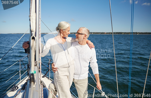 Image of senior couple hugging on sail boat or yacht in sea