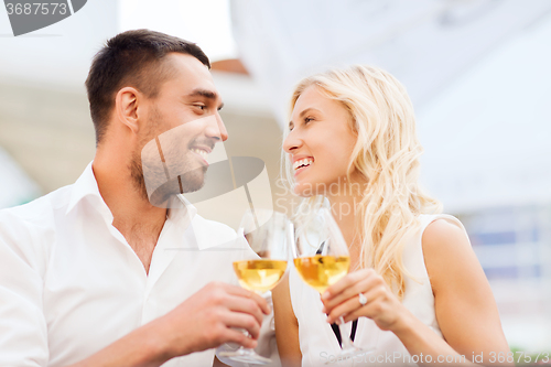 Image of happy couple clinking glasses at restaurant lounge