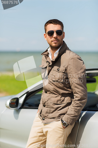 Image of man near cabriolet car outdoors
