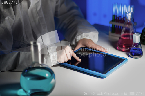 Image of close up of scientist with tablet pc in laboratory