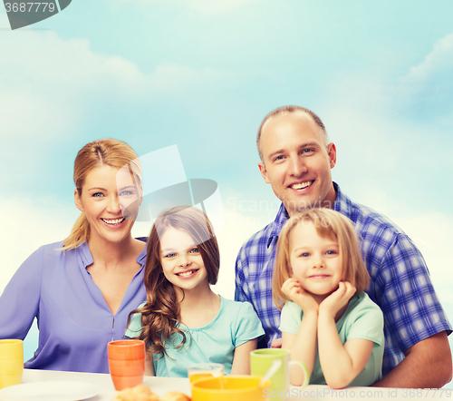 Image of happy family with two kids with having breakfast