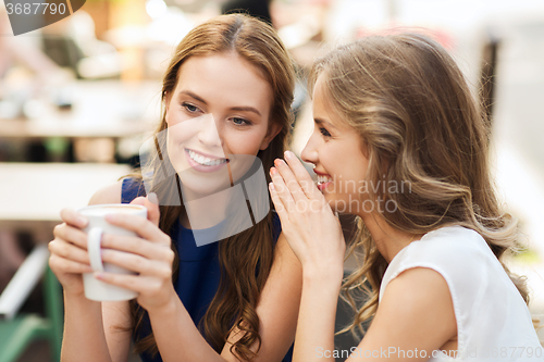 Image of young women drinking coffee and talking at cafe