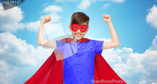 Image of boy in red super hero cape and mask showing fists