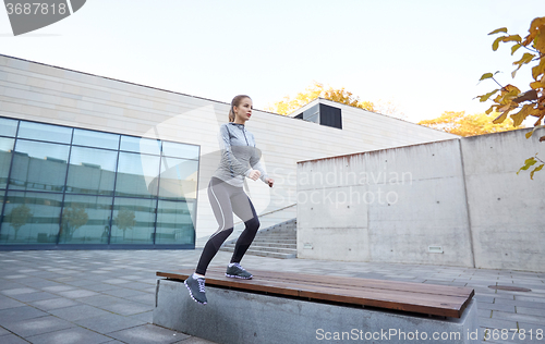 Image of woman exercising on bench outdoors