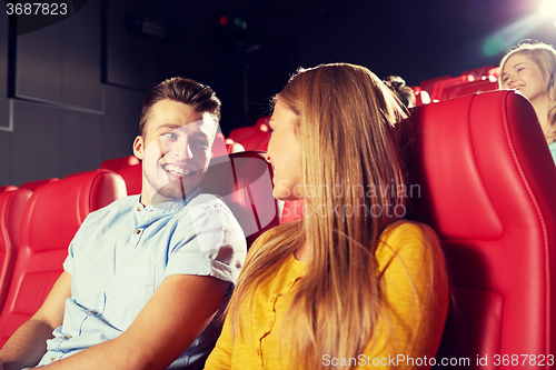 Image of happy friends watching movie in theater