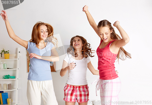 Image of happy friends or teen girls having fun at home