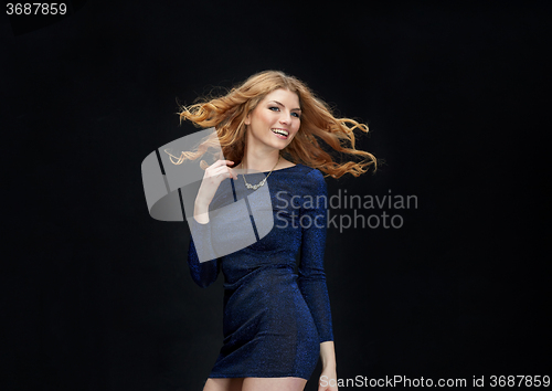 Image of happy young woman dancing at night club disco