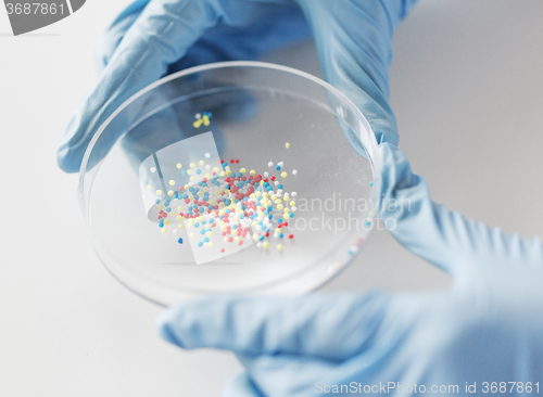 Image of close up of scientist hands holding chemical cure